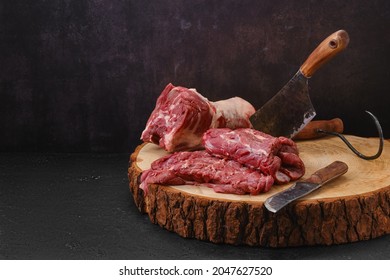 Pieces of fresh lamb neck on cutting stump in slaughterhouse
