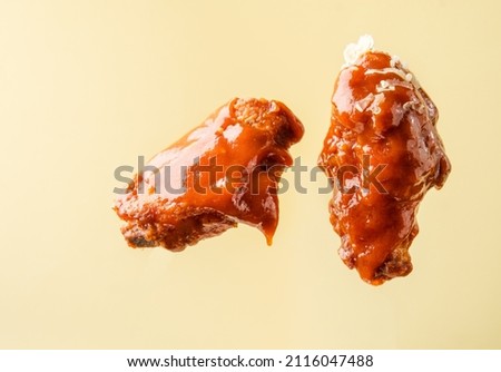 Pieces of fried chicken on a bright background. Buffalo chicken wings.