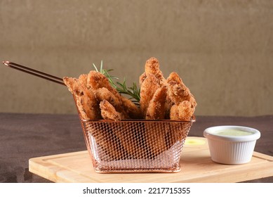 Pieces Of Fried Fish Breaded With Panko Flour Served With Herb Sauce, Cod.