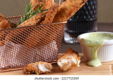 Pieces Of Fried Fish Breaded With Panko Flour Served With Herb Sauce, Cod.