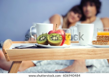 Image, Stock Photo Healthy breakfast on tray and couple lying in background