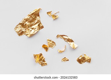 Pieces Of Golden Foil On White Background