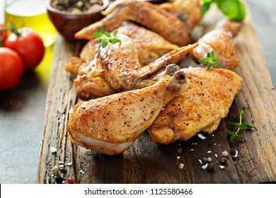 Pieces Of Grilled Or Smoked Chicken On A Wooden Board