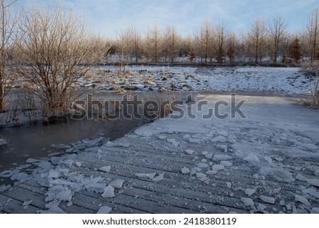 Pieces of ice on frozen bridge at the lake