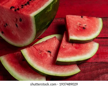 Pieces of juicy red watermelon on a wooden table. - Shutterstock ID 1937489029
