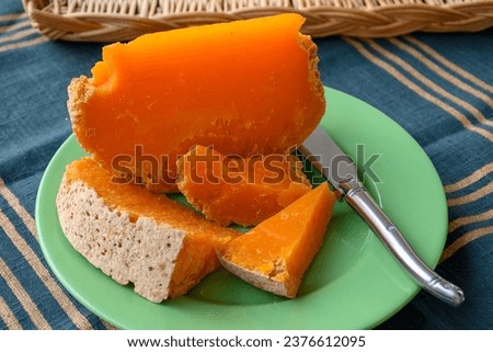 Pieces of native French aged cheese Mimolette, produced in Lille with greyish curst made by special cheese mites close-up