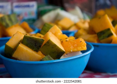 Pieces Of Papaya In A Blue Plastic Bowl