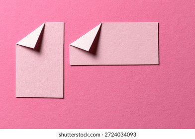 Pieces of paper notes or sheets with folded edge dog-ear earmark and copy space for text on pink background, top view flat lay