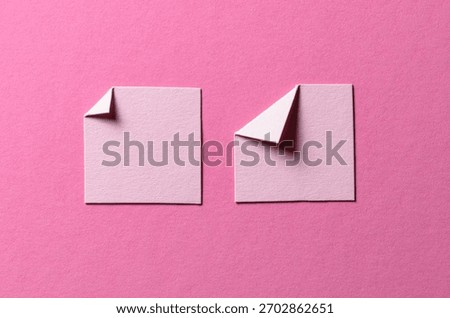 Pieces of paper notes or sheets with folded edge dog-ear earmark and copy space for text on pink background, top view flat lay