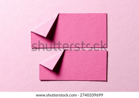 Pieces of paper notes or sheets with folded edge dog-ear earmark and copy space for text on light pink background, top view flat lay