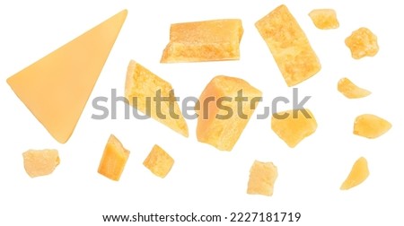 Pieces of parmesan cheese isolated on white background. Hard mature cheese Parmesan, Parmigiano in rough pieces top view, flat lay. Pattern
