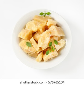 Pieces Of Parmesan Cheese In A Porcelain Bowl