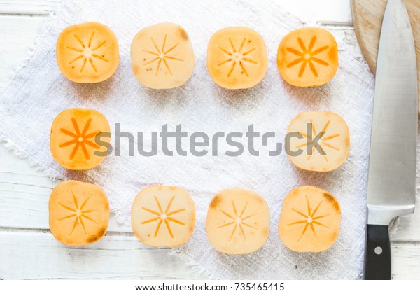 Pieces of\
persimmon fruit frame on white\
background.