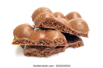 Pieces Of Porous Milk Chocolate On White Background