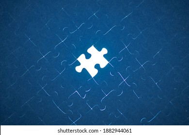 The pieces of the puzzle are connected. Business concept. the end of a large project, the last element. Missing jigsaw puzzle piece with light glow