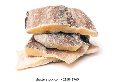 Pieces Of Salt Cod Fish Isolated On A White Studio Background.