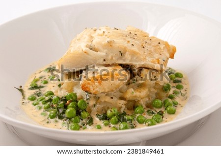 pieces of smoked haddock and pollock in a creamy cheese sauce with fresh peas Foto d'archivio © 