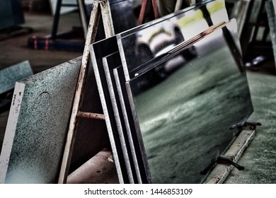 Pieces of stock of the natural stone marble slate ready stand on the holder on the ground with the beautiful classic low light exposure - Powered by Shutterstock