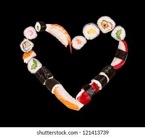 Pieces of sushi in heart shape, isolated on black background