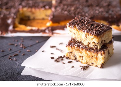 Pieces Of Tingling Cake With Milk Chocolate Frosting And Brigadeiro Sprinkles On Baking Paper