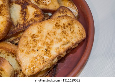 Pieces of toasted bread prepared on the pan. Toasts on the plate.