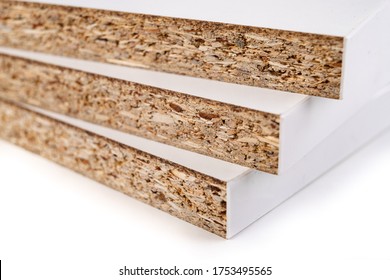Pieces of white chipboard stacked. Material for the construction of furniture in the carpentry shop. Workplace workshop. - Shutterstock ID 1753495565