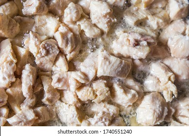 
Pieces Of White Meat Cut Into Cubes Are Photographed From A Top Angle Closeup.