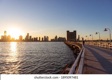 Pier 34 Along The Hudson River In New York City With A Sunset Over The Jersey City Skyline