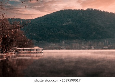 pier house standing on the foggy lake at sunrise and wonderful mountain and lake view - Powered by Shutterstock