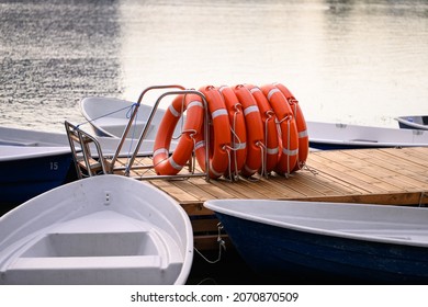 Pier With Lifebuoy And Boats . Boat For Walking. Boat Rental. Relax In The Summer. Outdoor Recreation.