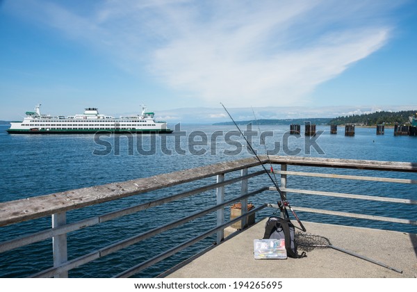 Pier with recreational fishing gear and car ferry.
 Copy space.