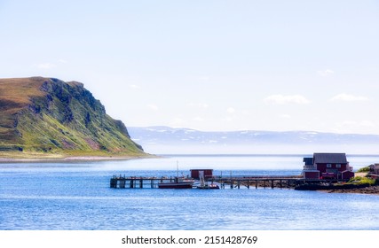 Pier in the Small Village of Sarnes in Nordkapp Municipality, Norway, with the Island Store Altsula