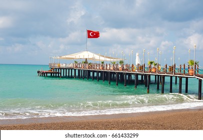 A Pier With A Turkish Flag On The Beach In Side. Turkey