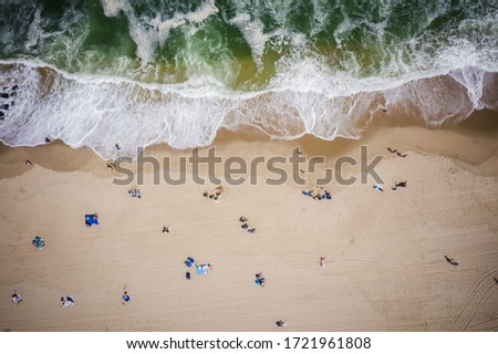 Similar – Luftaufnahme von fliegenden Drohnen von Menschen, die sich am Algarve Beach in Portugal entspannen.