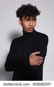 Pierced African American Man In Black Turtleneck Sweater Looking Away On Grey