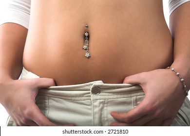 Pierced belly, jeans and hands isolated on white