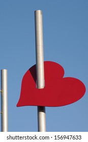A Pierced Red Heart and two Steel Masts 