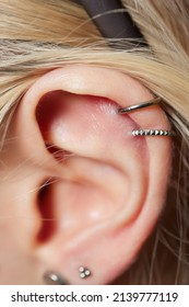 Piercings On An Ear. Conch And Helix Piercings Close Up.