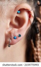 Piercings On An Ear. Conch And Helix Piercings Close Up.