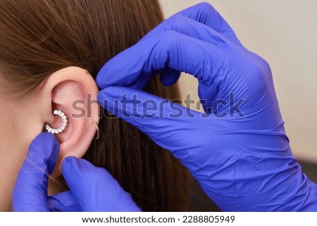 piercings on an ear. Conch and helix piercings close up