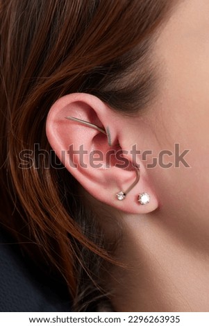 piercings on an ear. Conch and helix piercings close up
