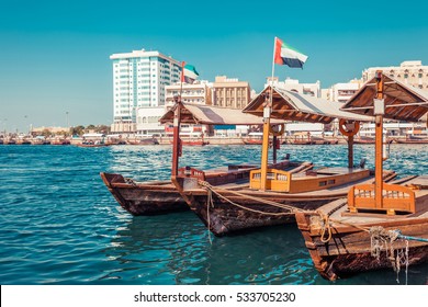 Piers of traditional water taxi boats in Dubai, UAE. Panoramic view on Creek gulf and Deira area. Creative color post processing. Famous tourist destination