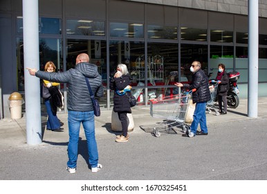 Pietrasanta, Lucca/Italy - Mar 11 2020 : Coronavirus In Italy, People Lined Up Waiting For Their Turn To Enter To The Supermarket