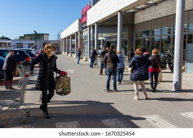 Pietrasanta, Lucca/Italy - Mar 11 2020 : Coronavirus In Italy, People Lined Up Waiting For Their Turn To Enter To The Supermarket