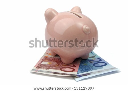 pig bank from back side on euro banknotes