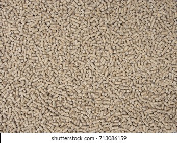 Pig feed pellets as background.