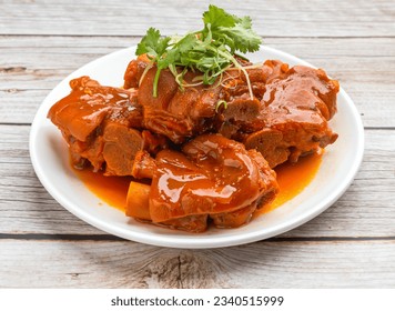 pig feet with red fermented beancurd served in dish isolated on wooden table top view hong kong food - Powered by Shutterstock