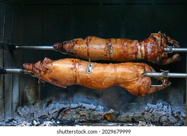 Pig roasted on a barbecue spit. Outdoor Barbecue grill a classic traditional open bbq pit. Steaks and meat cooked on a wood fire grill. . High quality photo