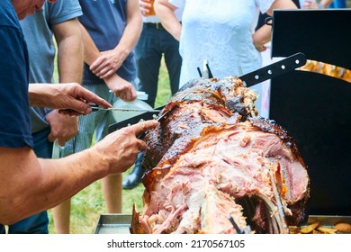 Pig roasted on a barbecue spit. Outdoor Barbecue grill a classic traditional open bbq pit. Steaks and meat cooked on a wood fire grill. Selective focus