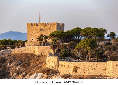 Pigeon Island castle in Kusadasi, close up of citadel central part in golden sunset hues. Famous tourist destination point in Kusadasi, Aidyn, Turkiye (Turkey) - Powered by Shutterstock